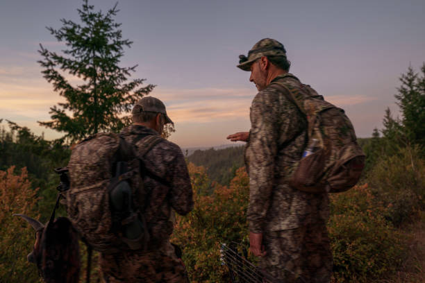 istock Two hunters hike on a mountainous trail at dawn 1649016278