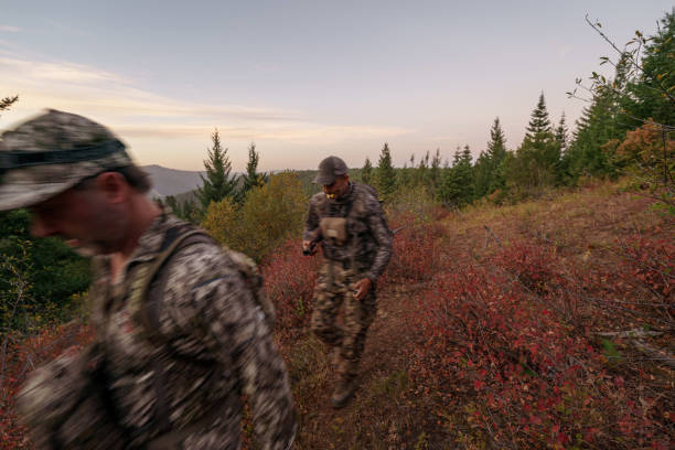 istock Two hunters hike on a mountainous trail at dawn 1649016295