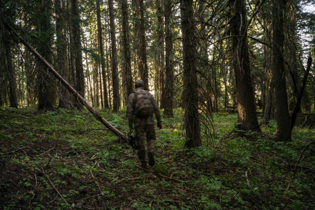 istock Male hunting hiking through forest in Pacific Northwest 1649016854