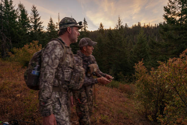 istock Two hunters hike on a mountainous trail at dawn 1649016861