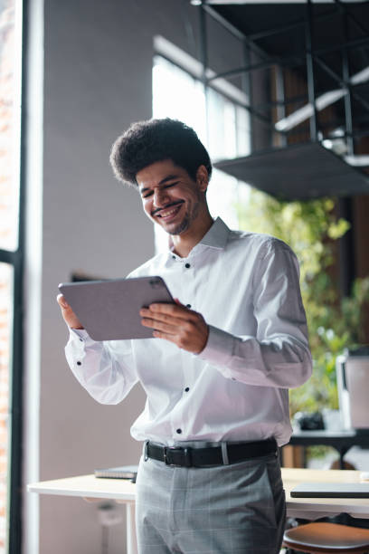istock A Happy Handsome Businessman Working On His Tablet 1649044977