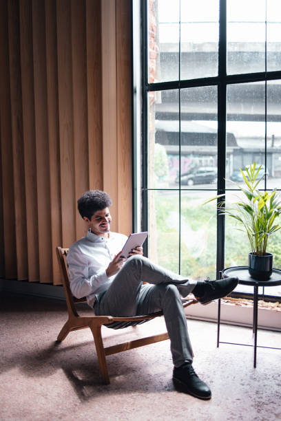 istock A Happy Handsome Businessman Watching Something On His Tablet While  Relaxing In The Office 1649044994