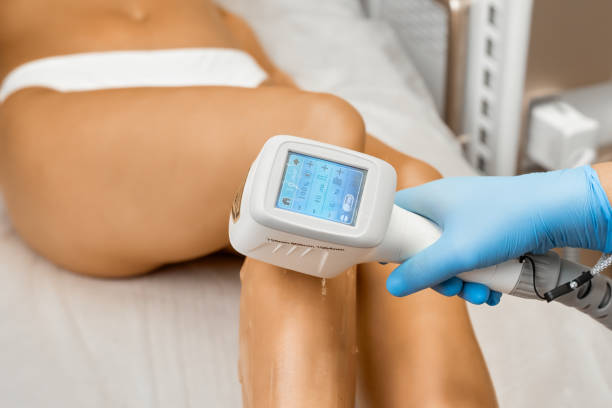 istock Expert runs laser hair removal device on lady client leg 1649045173