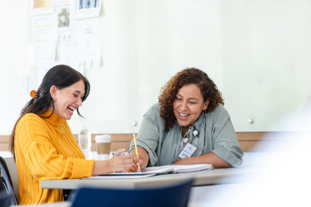 istock Cheerful university student shares laugh with tutor 1649072429