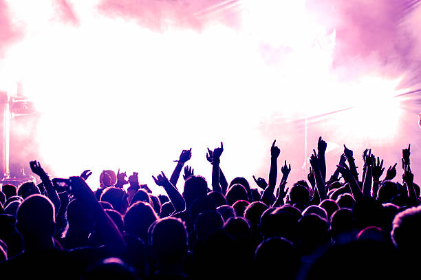 istock Enthusiastic audience at concert against bright stage 164907783
