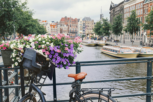 A bicycle parked on a bridge over one of the canals in Amsterdam, Holland