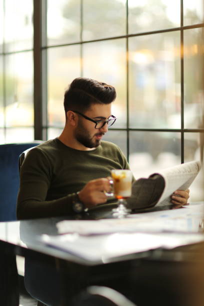 istock Young handsome man drinking coffee at a cafe 1649121041