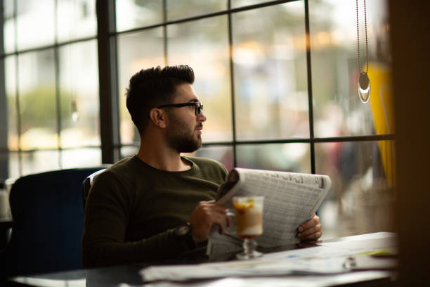 istock Young handsome man drinking coffee at a cafe 1649121043