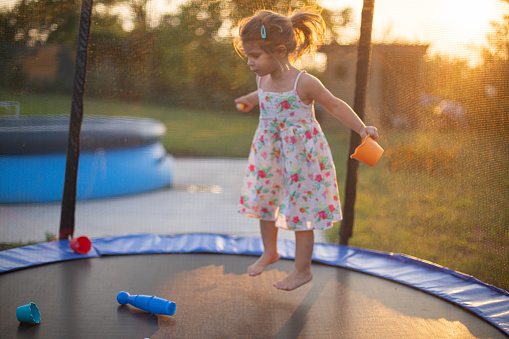 Little girl playing on a trampoline