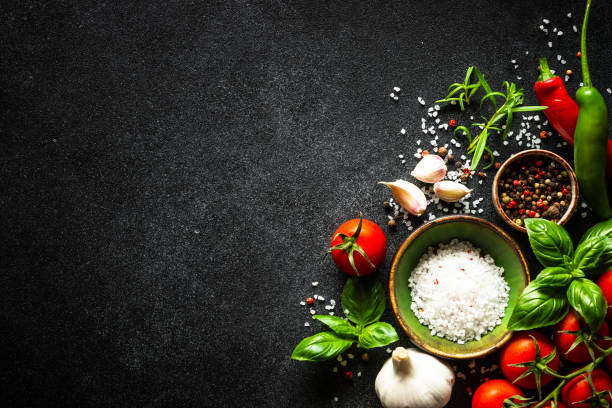 istock Food cooking background on black stone table. 1649170050