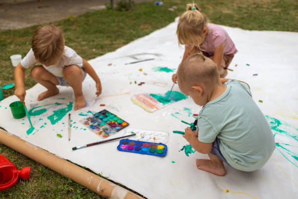 istock Happy kids playing with watercolors 1649170122