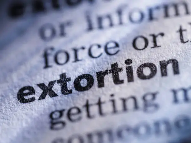 Photo of Word written in dictionary, extortion