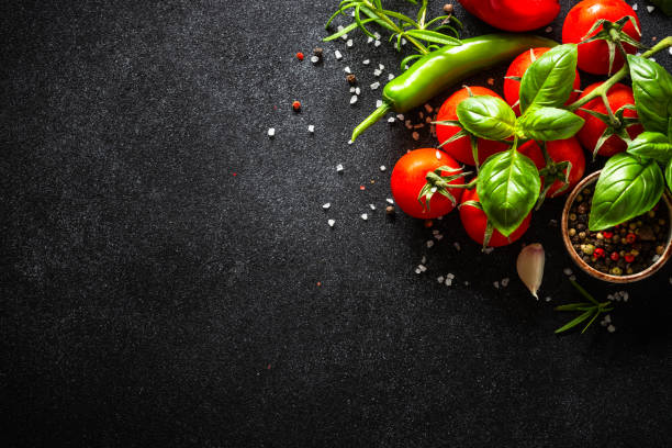 istock Food cooking background on black stone table. 1649170383