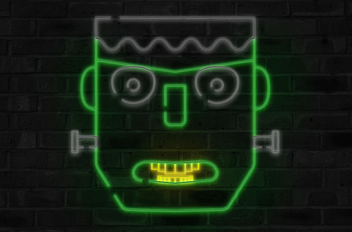 Neon Frankenstein head on brick background