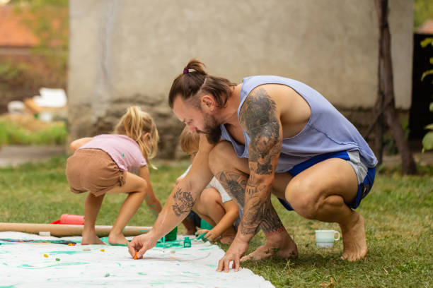 istock Father of three teaching kids how to paint 1649179177