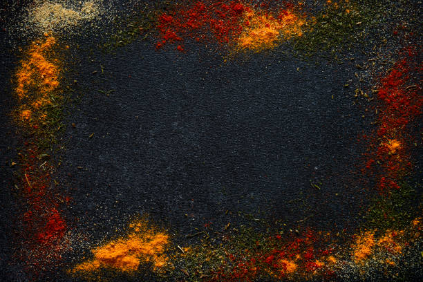 istock Spices powder on black slate background top view. 1649183413