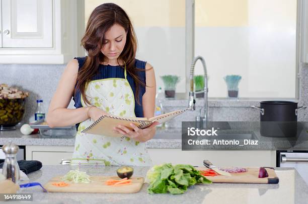 Beautiful Housewife Cooking A Recipe Stock Photo - Download Image Now - Adult, Apron, Beautiful People