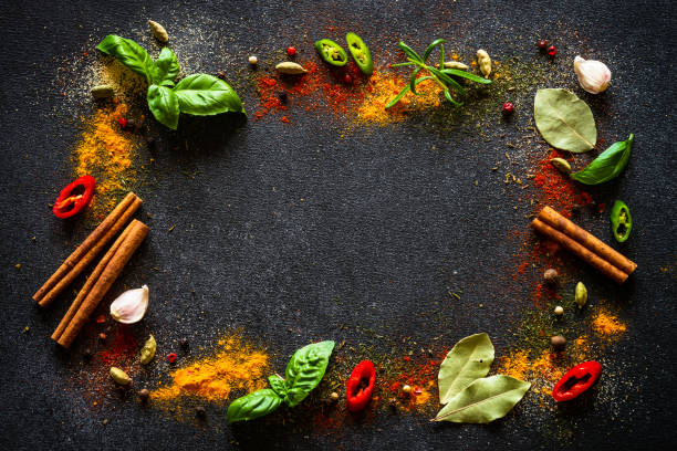 istock Spices and herbs on black slate background. 1649184964