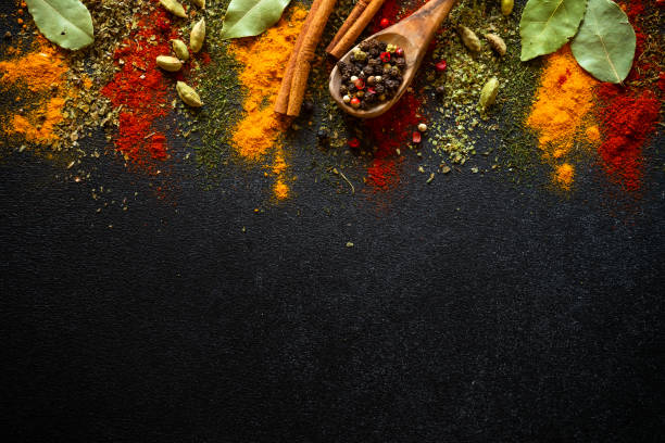 istock Spices and herbs on black slate background. 1649186569