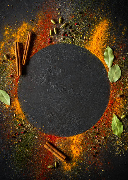 istock Spices and herbs on black slate background. 1649188193