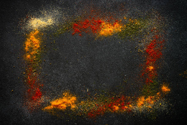 Spices powder on black slate background top view.