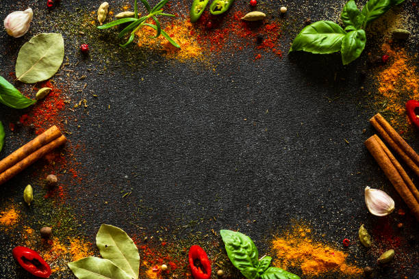 istock Spices and herbs on black slate background. 1649195095