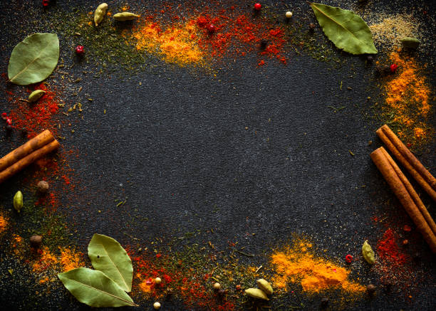 istock Spices and herbs on black slate background. 1649195097