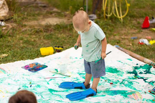 One happy child with a great idea decided to put on some flippers and paint