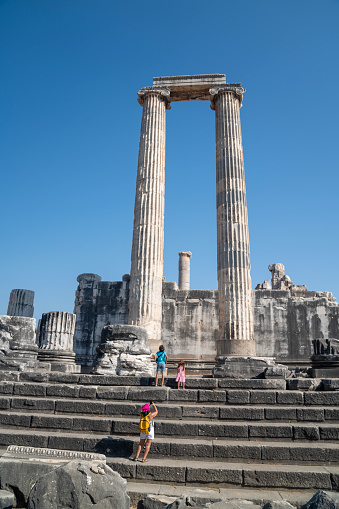Full length photo of mother, 10 years old son and 5 years old daughter visiting ancient Greek city of Didyma in Aydin Province, Turkey. Shot during day time with a full frame mirrorless camera.