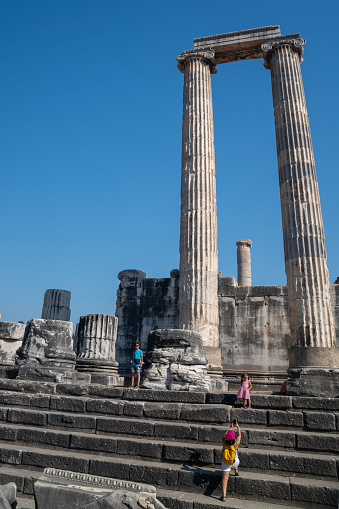 Full length photo of mother, 10 years old son and 5 years old daughter visiting ancient Greek city of Didyma in Aydin Province, Turkey. Shot during day time with a full frame mirrorless camera.