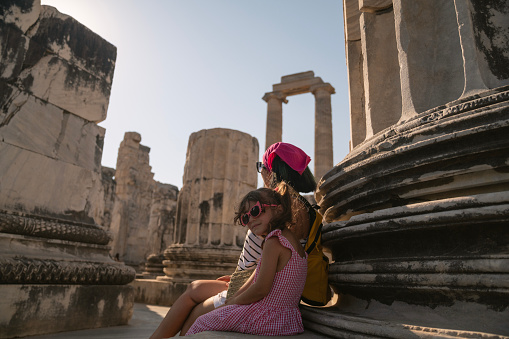 Photo of mother and 5 years old daughter visiting ancient Greek Temple of Apollo in Didyma, Aydin, Turkey. Shot with a full frame mirrorless camera.