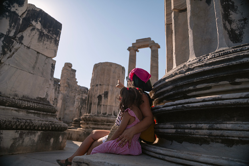 Photo of mother and 5 years old daughter visiting ancient Greek Temple of Apollo in Didyma, Aydin, Turkey. Shot with a full frame mirrorless camera.