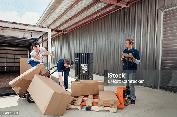 Careless Dock Workers Dropping Delivery Boxes While Loading Truck Stock Photo - Download Image Now