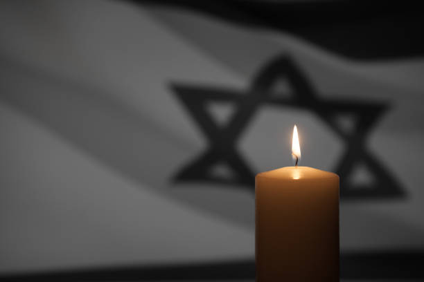 Burning candle on Israel flag background.