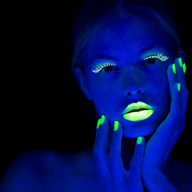Women Portrait with Lime Green Fingernails in Neon Light Young women portrait in Ultraviolet Light with Lime Green Eyelashes, lips and Fingernails. body paint photos stock pictures, royalty-free photos & images