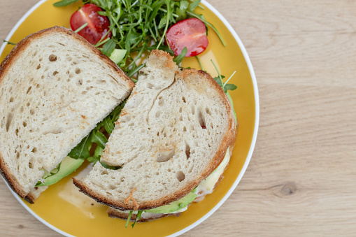 A sandwich plate with greens on the side