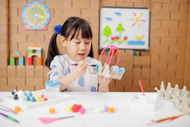 front view of young girl was making craft at home