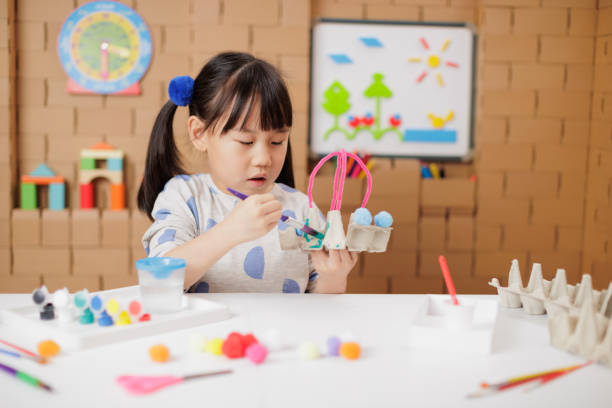 front view of young girl was making craft at home