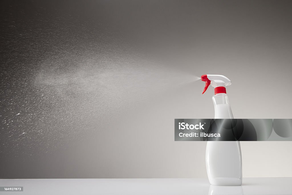 Spray bottle studio shot on gray gradient background Spray Stock Photo