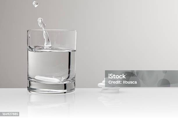 Aspirin Paracetamol Pill Splashing Into Glass Of Water Stock Photo - Download Image Now