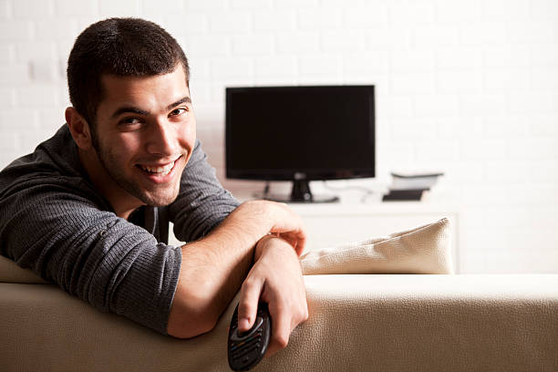 istock Man Watching Widescreen TV At Home 164928008