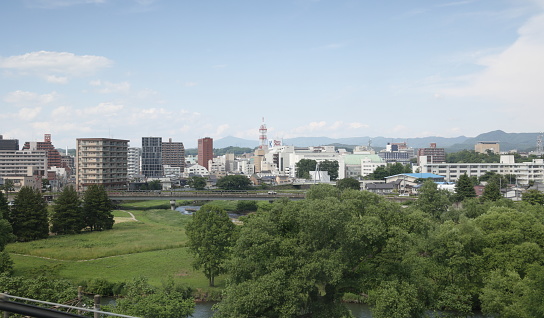 Morioka, Japan - June 10, 2023: High angle view of Kitakami River Park in Osawakawara near Morioka Station. Spring afternoon in Iwate Prefecture.