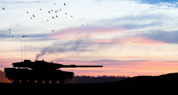 istock Silhouette of army tank at sunset sky background. 1649282005