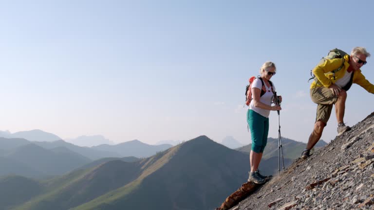 Mountaineer gives a helping hand to partner struggling up slope