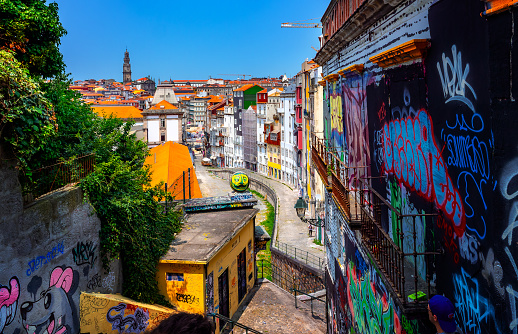 Porto, Portugal, Europe - June 26, 2023: Panoramic view of traditional narrow street and historical houses in the City of Porto on a sunny day