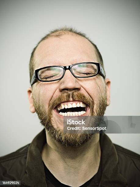 Man Having A Good Laugh Over Gray Background Stock Photo - Download Image Now - Mug Shot, Laughing, Smiling