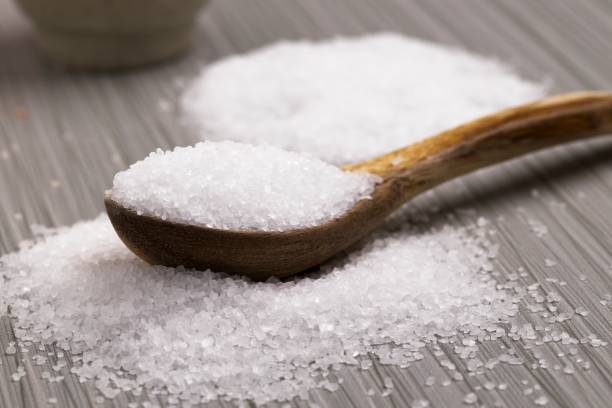 istock Coarse sea salt piled on a wooden spoon. 1649294597