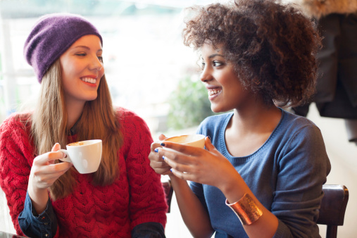 Two young girls drinking coffee togetherhttp://bit.ly/1bpN6TE