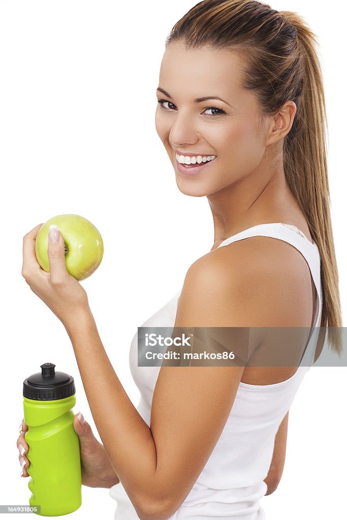 Mujer de gimnasio con botella y manzana - Foto de stock de Beber libre de derechos