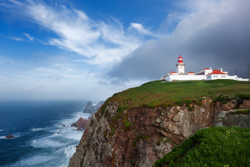 Cabo da Roca Lighthouse in the portuguese coast near Cascais with a storm coming.Westernmost point of mainland Europe. It is situated in the municipality of Sintra, Lisbon district.